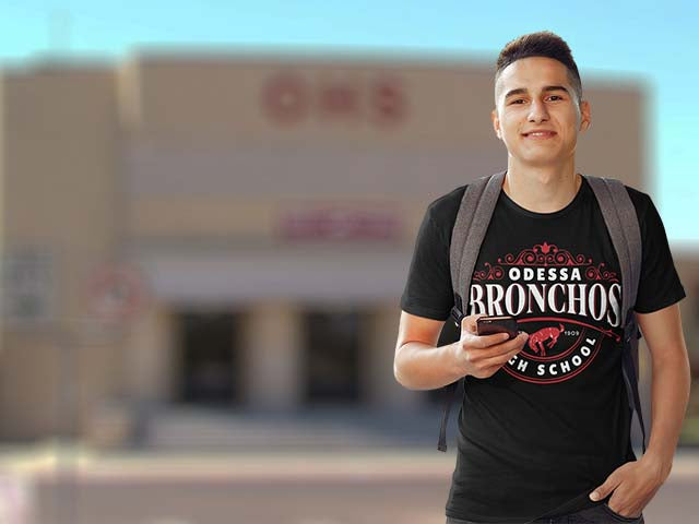 Person wearing an Odessa Bronchos high school t-shirt standing outdoors with a blurred background - Premium T-shirt design 211