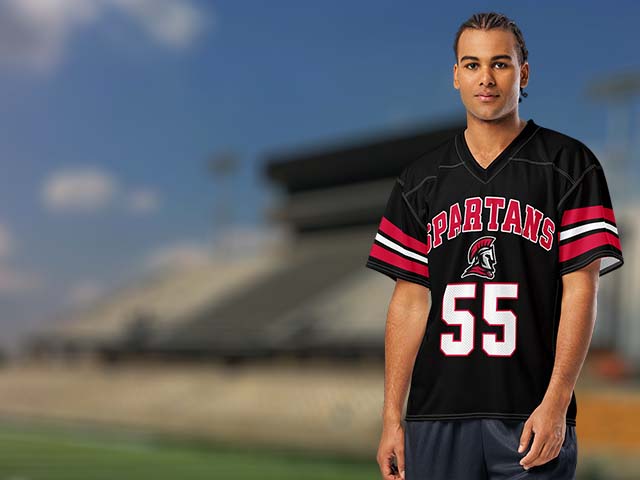 Person wearing a Spartans sports jersey with number 55 on a blurred stadium background - Porter High School