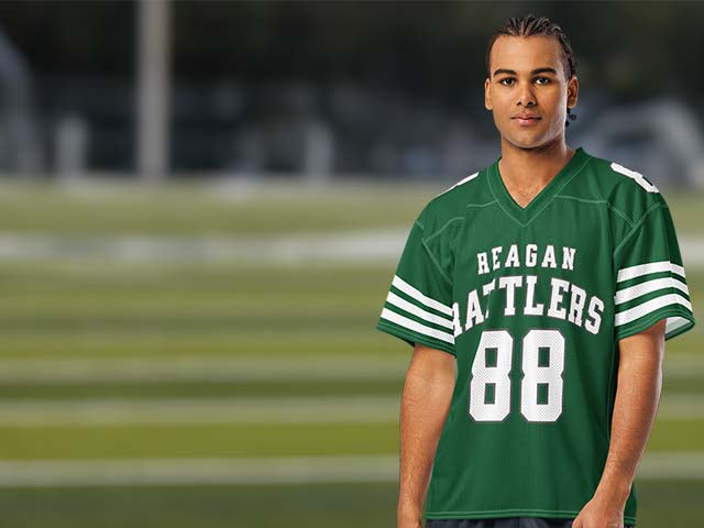 Person wearing a green 'Reagan Rattlers' jersey with the number 88 on a football field background.