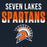 Seven Lakes Spartans graphic with the words 'SEVEN LAKES' in white and 'SPARTANS' in orange fading to white, above a Spartan helmet logo on a dark navy background. Seven Lakes High School Spartans Women's Navy Blue SoftStyle T-shirt 024