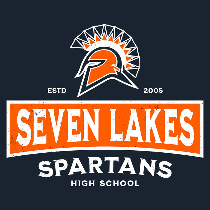 A school logo graphic for Seven Lakes Spartans High School on a dark navy background. The design features an orange and white Spartan helmet with a geometric crest, the text 'ESTD 2005' in white, a large orange banner with 'SEVEN LAKES' in distressed white letters, and 'SPARTANS HIGH SCHOOL' below in white. Seven Lakes High School Spartans Women's Navy Blue SoftStyle T-shirt 202