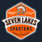 A vintage-style school crest graphic reading 'SEVEN LAKES SPARTANS HIGH SCHOOL' with a Spartan helmet emblem and the phrases 'GAME DAY READY' and 'LET'S GO TEAM' on a dark navy background. Seven Lakes High School Spartans Women's Navy Blue SoftStyle T-shirt 209