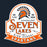 A vintage-style school crest graphic for Seven Lakes High School Spartans, featuring an orange and white Spartan helmet with a sunburst, the words 'One Team One Dream,' 'Established 2005,' and 'Seven Lakes High School Spartans' on a dark navy background. Seven Lakes High School Spartans Navy Blue Classic Unisex T-shirt 219