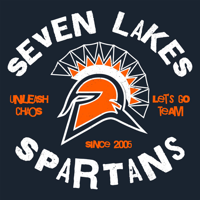 A dark navy graphic design featuring a Spartan helmet with an orange face and white outline, surrounded by a geometric fan motif. The text 'SEVEN LAKES SPARTANS' is written in large distressed white letters, with 'UNLEASH CHAOS' and 'LET'S GO TEAM' in orange on either side, and 'since 2005' below the helmet. Seven Lakes High School Spartans Women's Navy Blue SoftStyle T-shirt 228