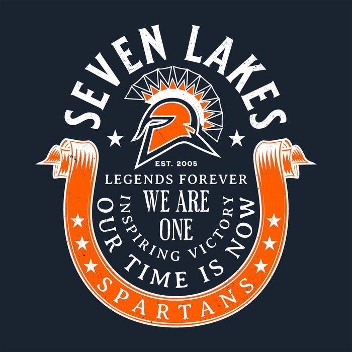 A circular graphic design featuring a Spartan helmet and the text 'SEVEN LAKES' at the top, 'LEGENDS FOREVER', 'WE ARE ONE', 'OUR TIME IS NOW', and 'SPARTANS' on an orange ribbon at the bottom, on a dark navy background. Seven Lakes High School Spartans Women's Navy Blue SoftStyle T-shirt 229