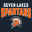 A dark navy graphic design featuring the text 'SEVEN LAKES SPARTANS' in white and orange, with an orange and white Spartan helmet logo below. Seven Lakes High School Spartans Women's Navy Blue SoftStyle T-shirt 234