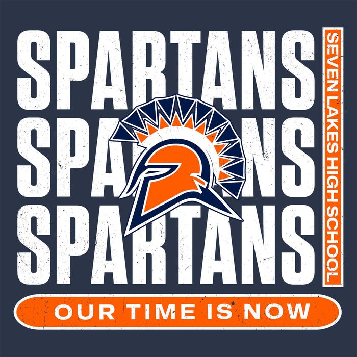 A dark navy graphic design featuring the word 'SPARTANS' repeated in large distressed white letters, with a central Spartan helmet logo in orange, navy, and white. A vertical orange strip on the right reads 'SEVEN LAKES HIGH SCHOOL,' and an orange rounded bar at the bottom reads 'OUR TIME IS NOW. Seven Lakes High School Spartans Unisex 3/4 sleeve Raglan T-shirt 235