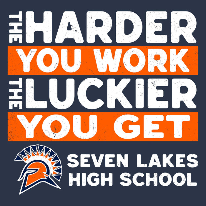 A square graphic design with the motivational phrase 'THE HARDER YOU WORK THE LUCKIER YOU GET' in white distressed text on alternating orange and dark navy blocks. Below the slogan is the Seven Lakes High School logo and the words 'SEVEN LAKES HIGH SCHOOL' in white on a dark navy background. Seven Lakes High School Spartans Unisex 3/4 sleeve Raglan T-shirt 238
