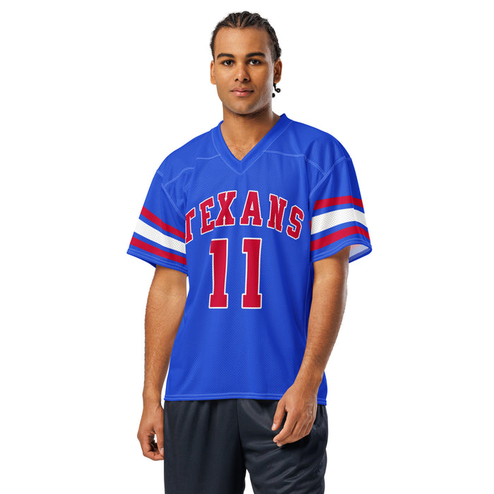 A man modeling a royal blue football jersey with 'TEXANS' and the number '11' in red with white outlines on the front, and white and red stripes on the sleeves, set against a plain white background. Sam Houston High School Texans Football Jersey 11