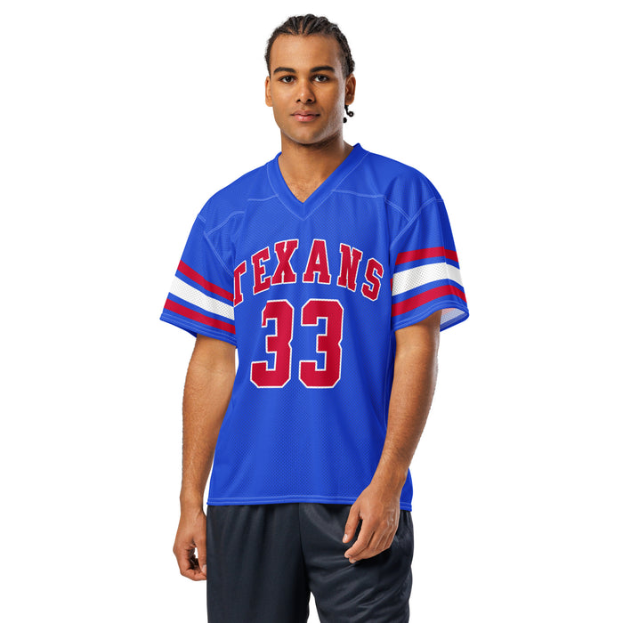 A man modeling a royal blue short-sleeve football jersey with 'TEXANS' and the number '33' in red with white outlines on the front, and white and red stripes on the sleeves, against a plain white background. Sam Houston High School Texans Football Jersey 33