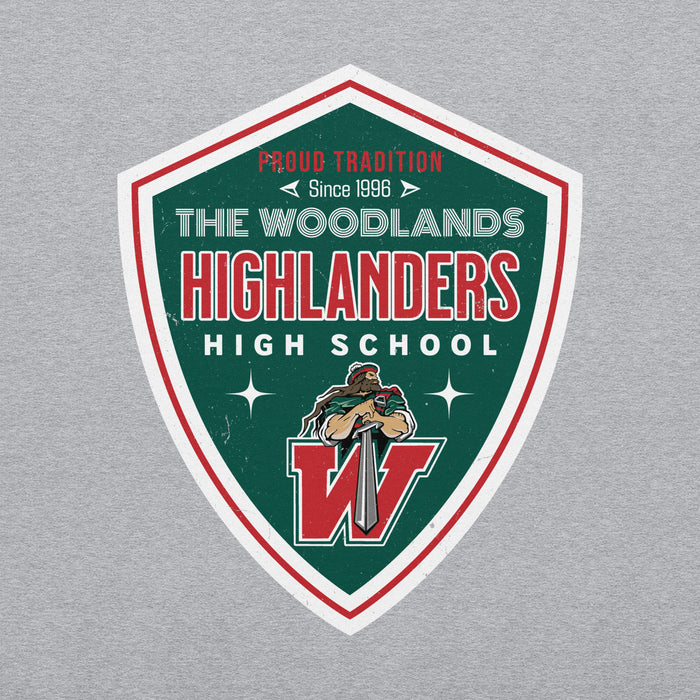 A shield-shaped graphic print on a light gray heathered fabric background. The graphic features a dark green background with a white border, red accents, and the text 'THE WOODLANDS HIGHLANDERS HIGH SCHOOL' along with a mascot holding a sword and a large red 'W'. The Woodlands High School Highlanders Grey Classic Unisex Sweatshirt 218