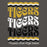 A graphic print featuring the word 'TIGERS' repeated three times in distressed typography, with wavy stripe accents in yellow, white, and black above and below. Below the main text reads 'Tomball West High School' in white script. Tomball West High School Tigers Dark Grey Classic Unisex Hoodie 227
