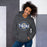 Woman wearing a Klein Collins High School Tigers Dark Heather Classic Unisex Hoodie 11