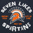 A graphic print on a dark navy shirt featuring a Spartan helmet with an orange and white design, surrounded by the text 'SEVEN LAKES SPARTANS' in distressed white lettering, with orange text reading 'UNLEASH CHAOS' and 'LET'S GO TEAM' and 'SINCE 2005'. Seven Lakes High School Spartans Navy Blue Premium Unisex Hoodie 228