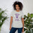 Woman wearing a Morton Ranch High School Mavericks Premium Athletic Heather Unisex T-shirt 218