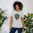 Woman wearing The Woodlands High School Highlanders Athletic Heather Premium Unisex T-shirt 225