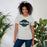 Woman wearing Reagan High School Rattlers Grey Premium Unisex T-shirt 011