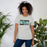 Woman wearing Reagan High School Rattlers Grey Premium Unisex T-shirt 098