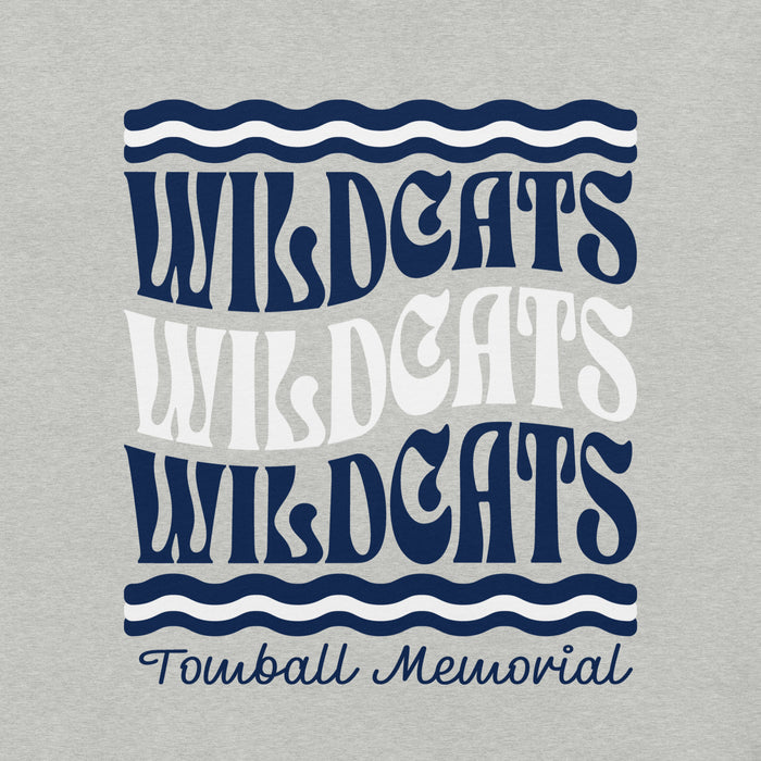 A close-up of a light heather gray fabric surface with a printed graphic reading 'WILDCATS' in three stacked rows and 'Tomball Memorial' below, using navy blue and white lettering with wavy line accents. Tomball Memorial High School Wildcats Grey Premium Unisex T-shirt 227