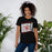 Woman wearing MacArthur High School Generals Black Premium Unisex T-shirt 223