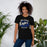 Woman wearing New Caney High School Eagles Black Premium Unisex T-shirt 253