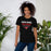 Woman wearing North Shore High School Mustangs Black Premium Unisex T-shirt 003