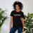 Woman wearing North Shore High School Mustangs Black Premium Unisex T-shirt 200