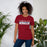 Woman wearing Tompkins High School Falcons Cardinal Red Premium Unisex T-shirt 031