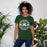 Woman wearing Reagan High School Rattlers Dark Green Premium Unisex T-shirt 203