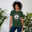 Woman wearing Reagan High School Rattlers Dark Green Premium Unisex T-shirt 216