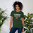 Woman wearing The Woodlands High School Highlanders Forest Green Premium Unisex T-shirt 003