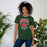 Woman wearing The Woodlands High School Highlanders Forest Green Premium Unisex T-shirt 204