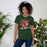 Woman wearing The Woodlands High School Highlanders Forest Green Premium Unisex T-shirt 205