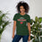 Woman wearing The Woodlands High School Highlanders Forest Green Premium Unisex T-shirt 040