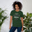 Woman wearing Reagan High School Rattlers Forest Green Premium Unisex T-shirt 034