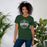 Woman wearing Reagan High School Rattlers Forest Green Premium Unisex T-shirt 209