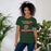 Woman wearing The Woodlands High School Highlanders Forest Green Premium Unisex T-shirt 006