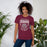 Woman wearing a Cinco Ranch High School Cougars Premium Maroon Unisex T-shirt 201