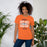 Woman wearing Seven Lakes High School Spartans Orange Premium Unisex T-shirt 210