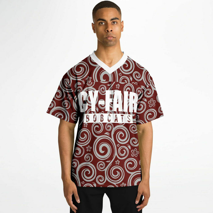 Black man wearing Cy-Fair Bobcats football Jersey