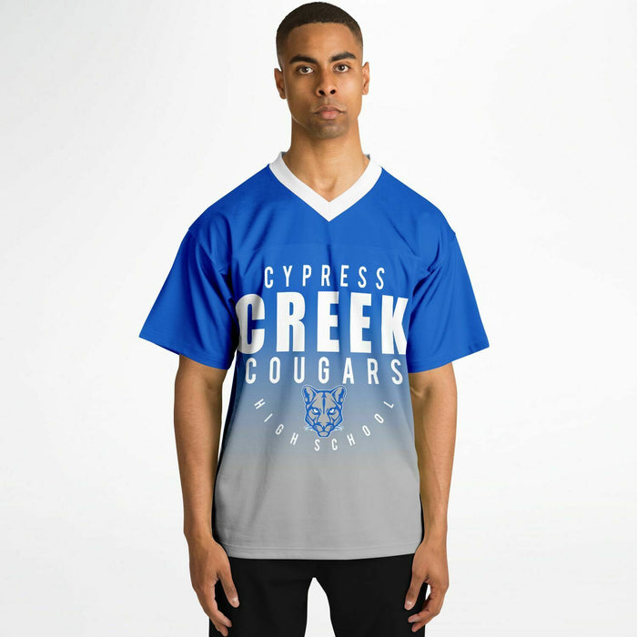 Black man wearing Cypress Creek Cougars football Jersey