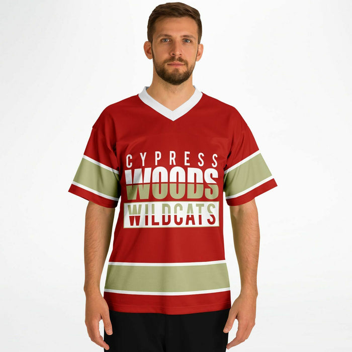 Man wearing Cypress Woods Wildcats football jersey 13