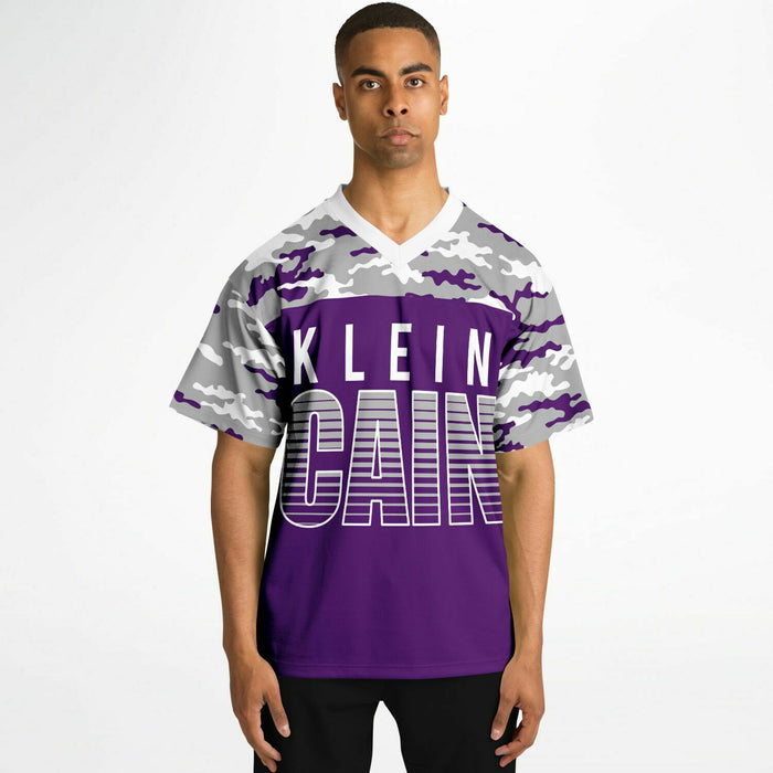 Black man wearing Klein Cain Hurricanes football Jersey