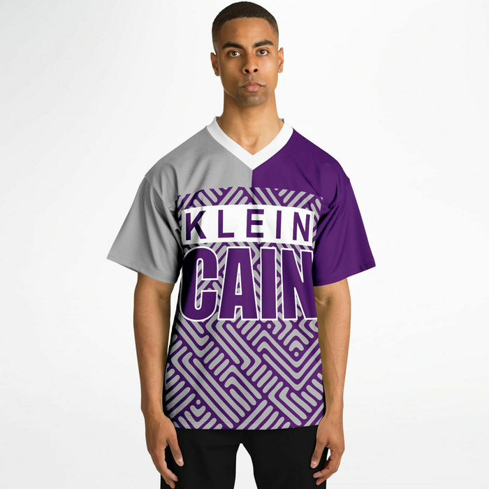 Black man wearing Klein Cain Hurricanes football Jersey