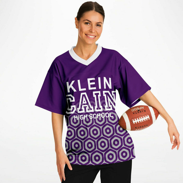 Woman wearing Klein Cain Hurricanes football jersey