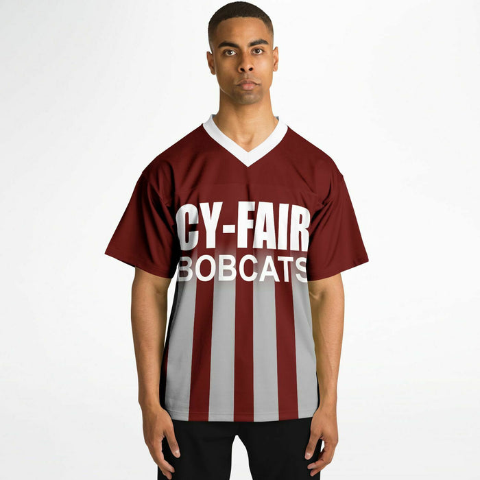 Black man wearing Cy-Fair Bobcats football Jersey