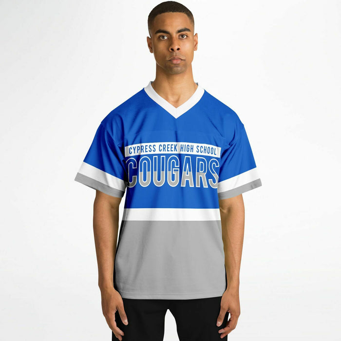 Black man wearing Cypress Creek Cougars football Jersey