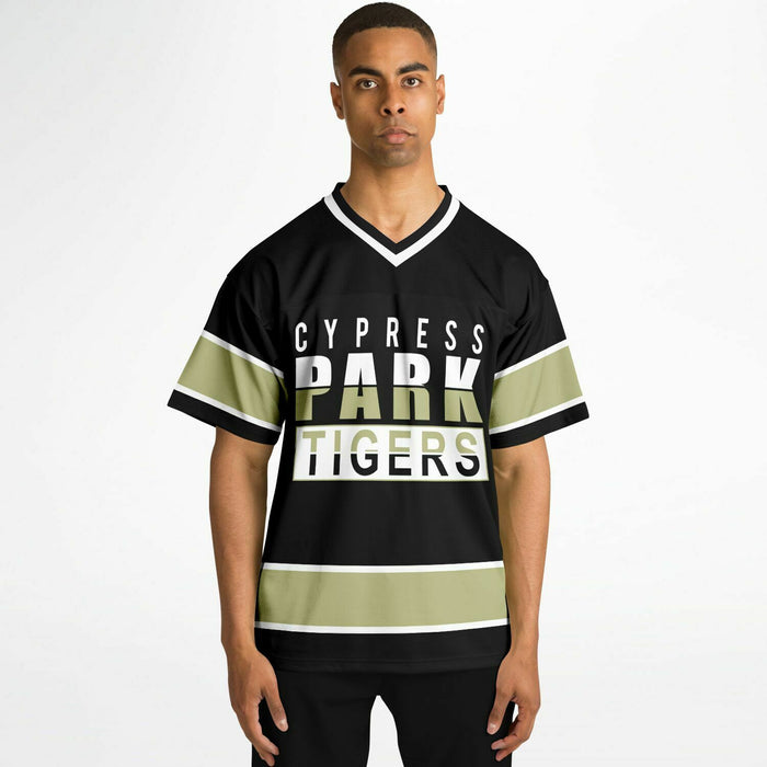 Black man wearing Cypress Park Tigers football jersey 13