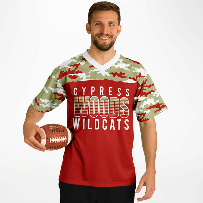 Man wearing Cypress Woods Wildcats football Jersey with football 08