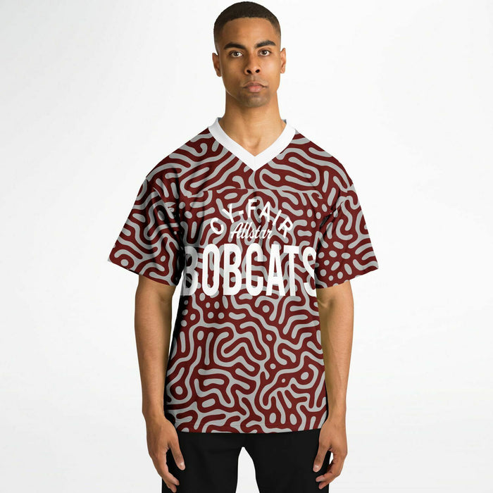 Black man wearing Cy-Fair Bobcats football Jersey